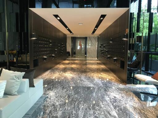 Modern building interior with marble flooring and mailboxes