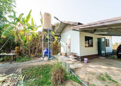 Exterior view of a building with water tank and carport