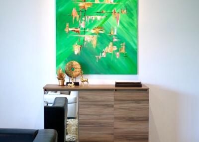 Modern living room with wooden cabinet and abstract green painting