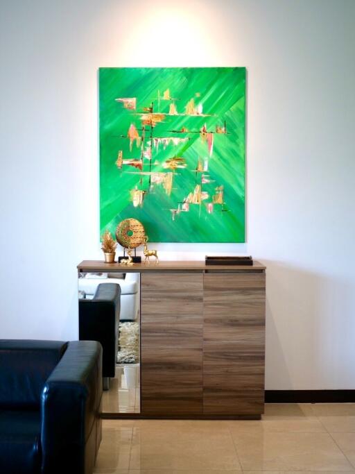 Modern living room with wooden cabinet and abstract green painting