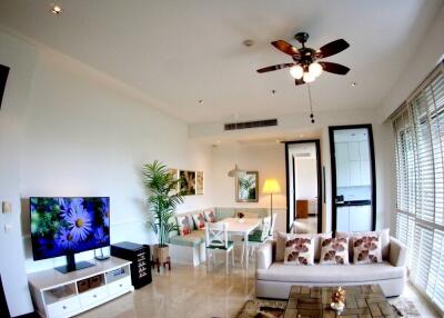 Modern living room with fan, sofa, and TV