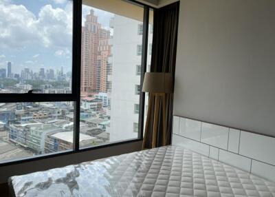 Bedroom with large window and city view