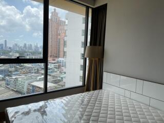 Bedroom with large window and city view