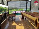 Covered balcony with seating and wooden daybed