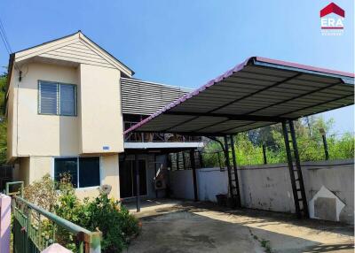 Exterior view of a two-story house with a carport