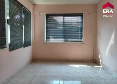 Empty bedroom with tiled floor and large windows