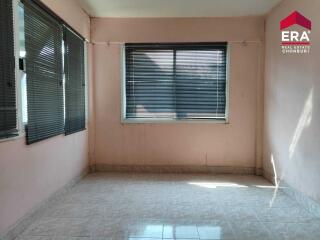 Empty bedroom with tiled floor and large windows