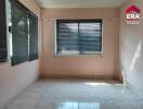 Empty bedroom with tiled floor and large windows