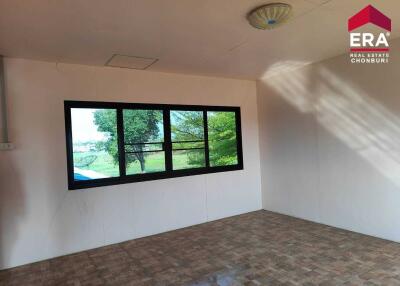 Empty room with large window and tiled floor