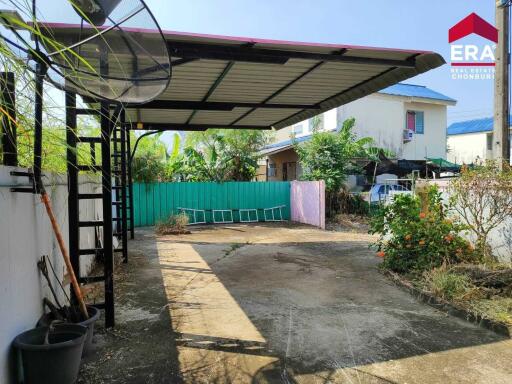 covered carport in backyard with garden area