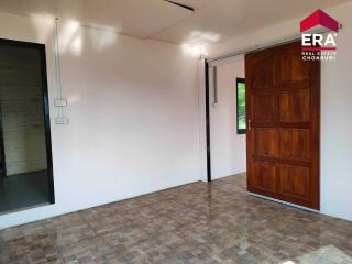 Spacious living area with wooden door and window