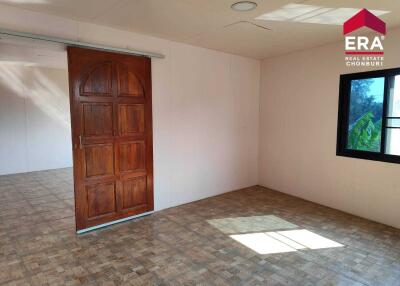 Spacious bedroom with wooden door and window