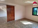 Spacious bedroom with wooden door and window