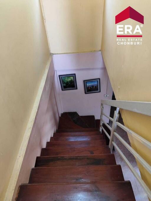 Indoor staircase with wooden steps and framed pictures on the wall