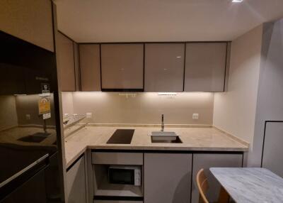 Modern kitchen with beige cabinetry and built-in appliances