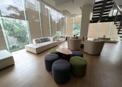 Modern living space with large windows and seating