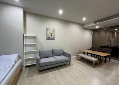 modern living area with grey sofa and dining table