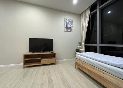 Minimalist bedroom with TV and bed