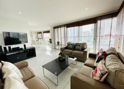 Spacious living room with modern furnishings and large windows