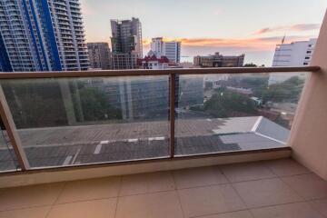 Balcony with a view of city buildings during sunset