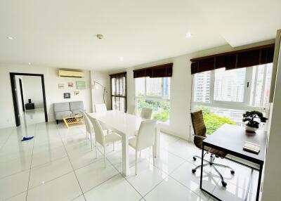 Living room with large windows and office area