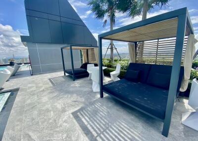 Rooftop terrace with seating and poolside cabanas