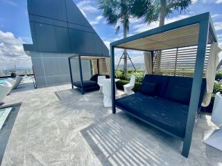 Rooftop terrace with seating and poolside cabanas