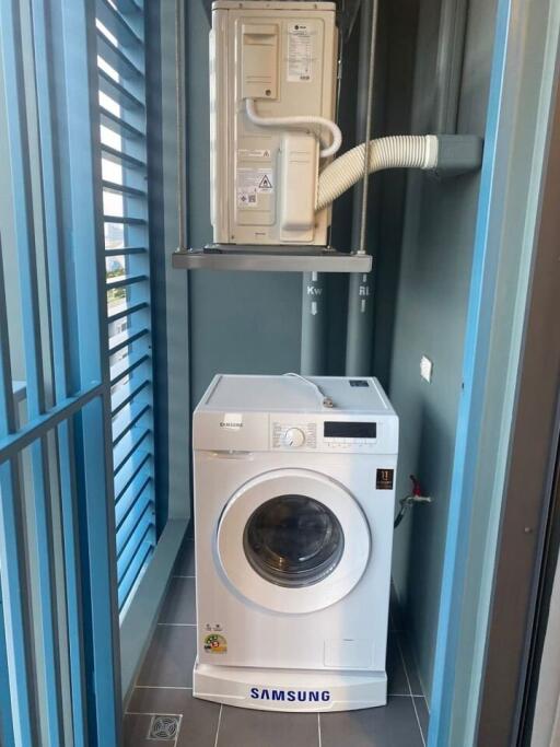 Laundry area with Samsung washing machine and HVAC system unit