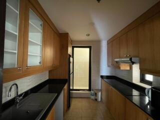 Modern kitchen with wooden cabinets and black countertops