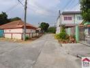 Street view in a neighborhood with houses on both sides