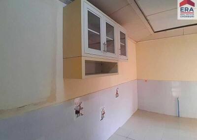 Simple kitchen with wall-mounted cabinets and tile flooring