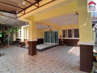 View of a covered patio area with tiled flooring and yellow walls