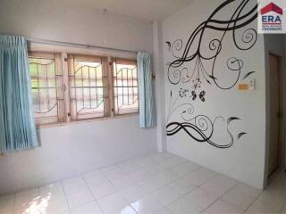 Bedroom with large windows and wall decoration