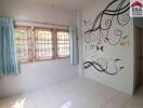 Bedroom with large windows and wall decoration