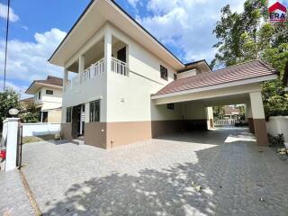 Two-story house with a driveway and a carport