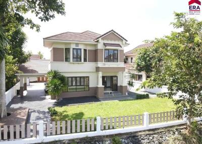 Exterior view of a two-story house with a well-maintained lawn