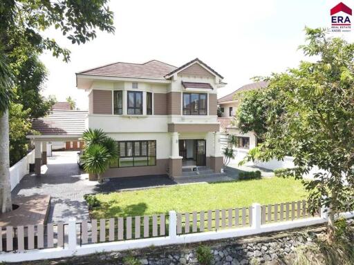 Exterior view of a two-story house with a well-maintained lawn