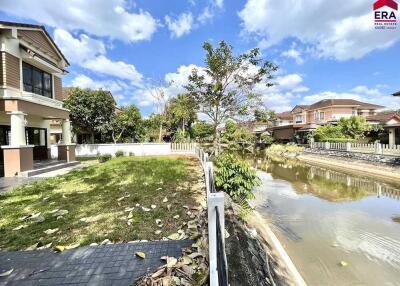 House with a backyard and canal