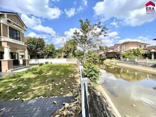 House with a backyard and canal