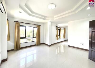 Spacious living room with large windows and polished floor