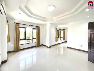 Spacious living room with large windows and polished floor