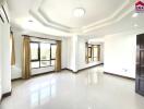 Spacious living room with large windows and polished floor