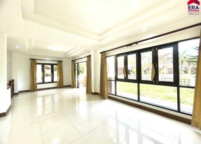 Bright living room with large windows and tiled floors