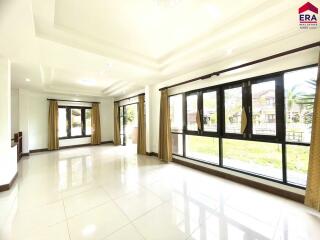 Bright living room with large windows and tiled floors