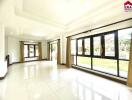 Bright living room with large windows and tiled floors