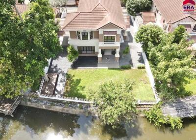 Aerial view of a residential house with yard and waterway