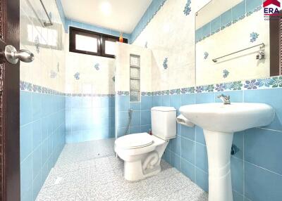 Well-lit bathroom with blue and white tiles