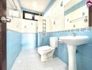 Well-lit bathroom with blue and white tiles