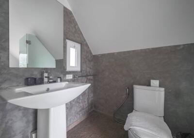 Modern bathroom with a pedestal sink and toilet