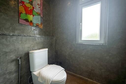 Modern bathroom with gray walls and a colorful painting